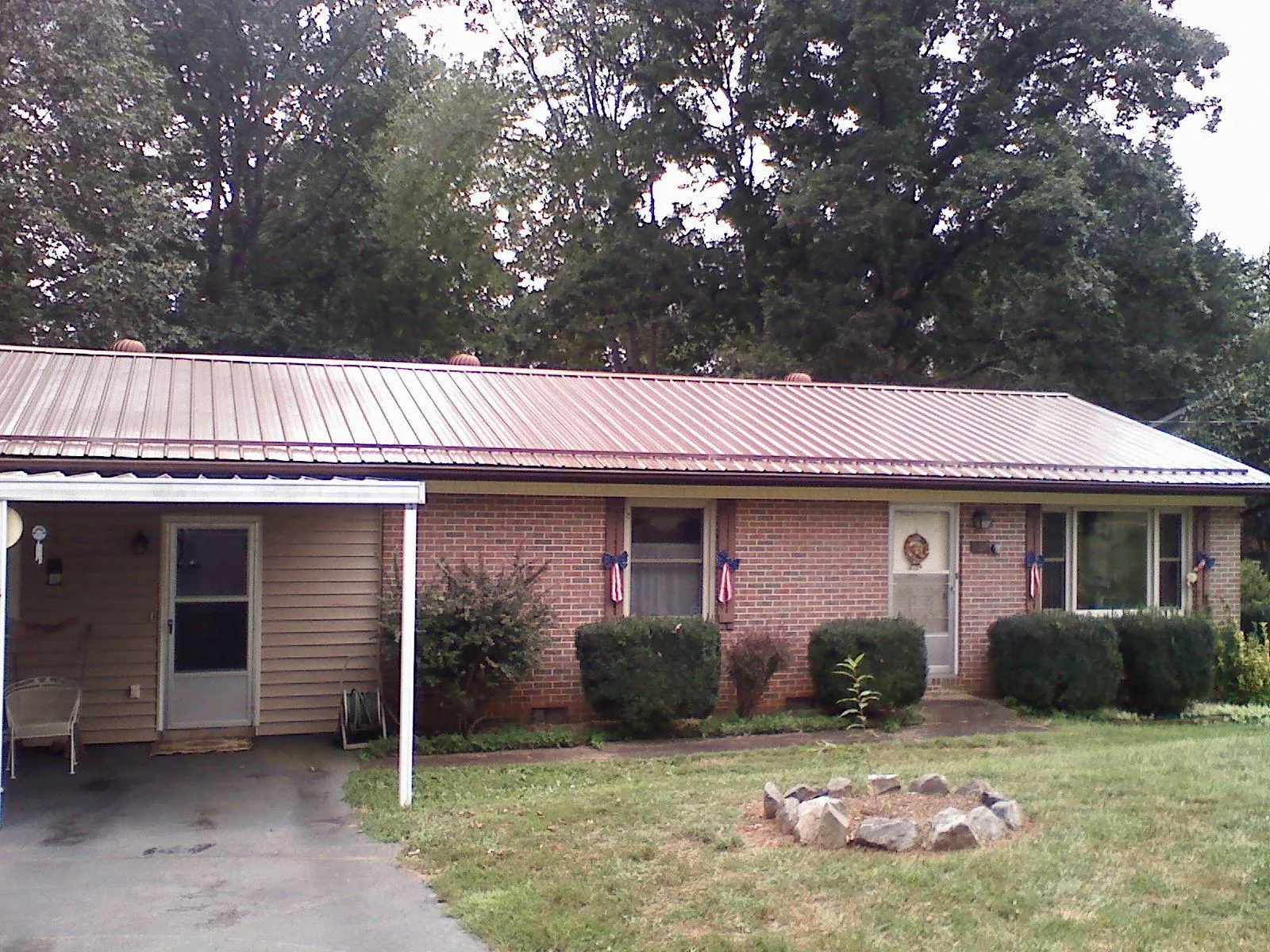 Bronze metal roof and carport on a brick ranch home — Roof Repair work by our crew in North Branford