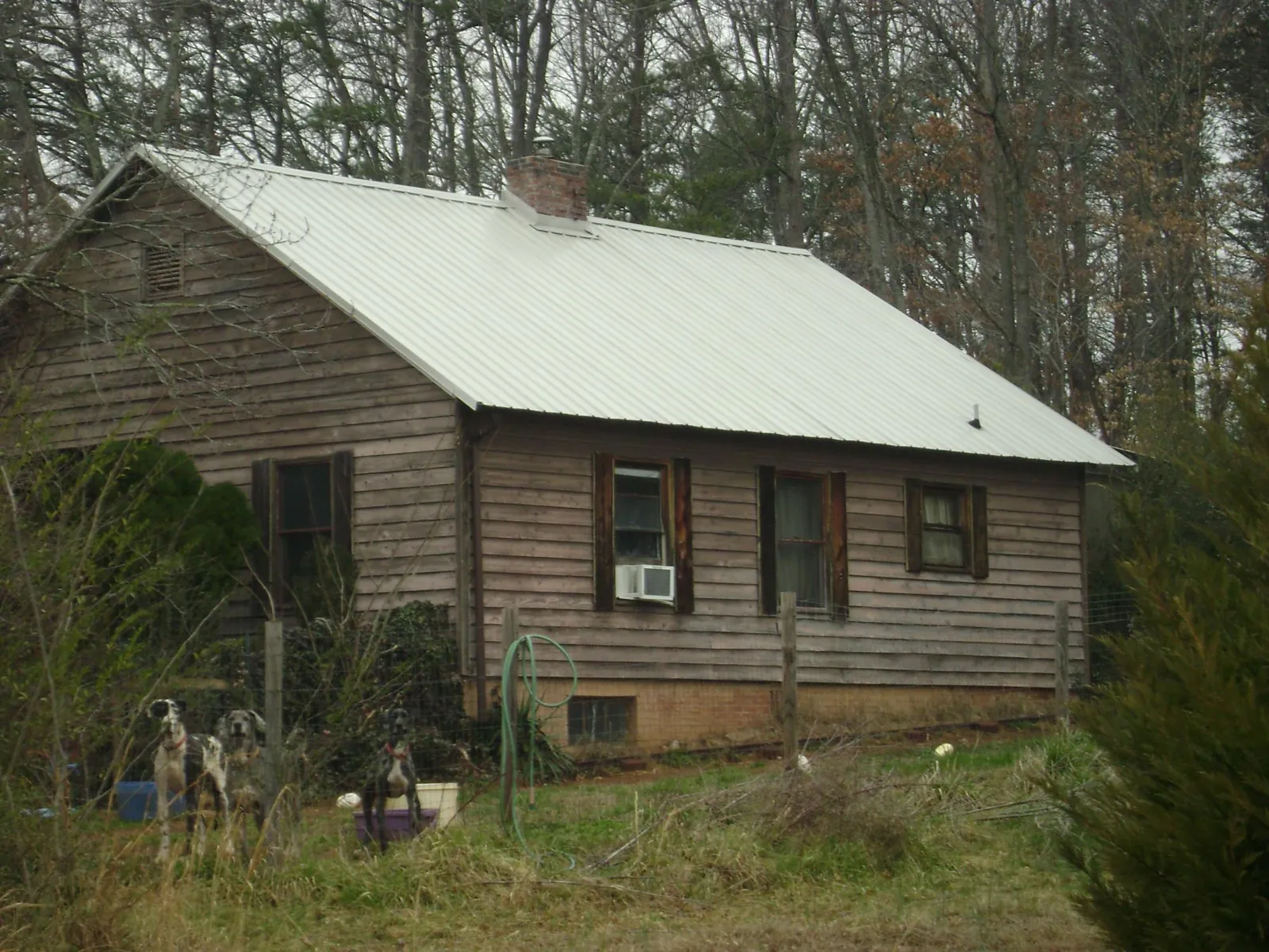 White metal roof on an old wood sided farmhouse, from a Metal Roof Installation job in North Branford